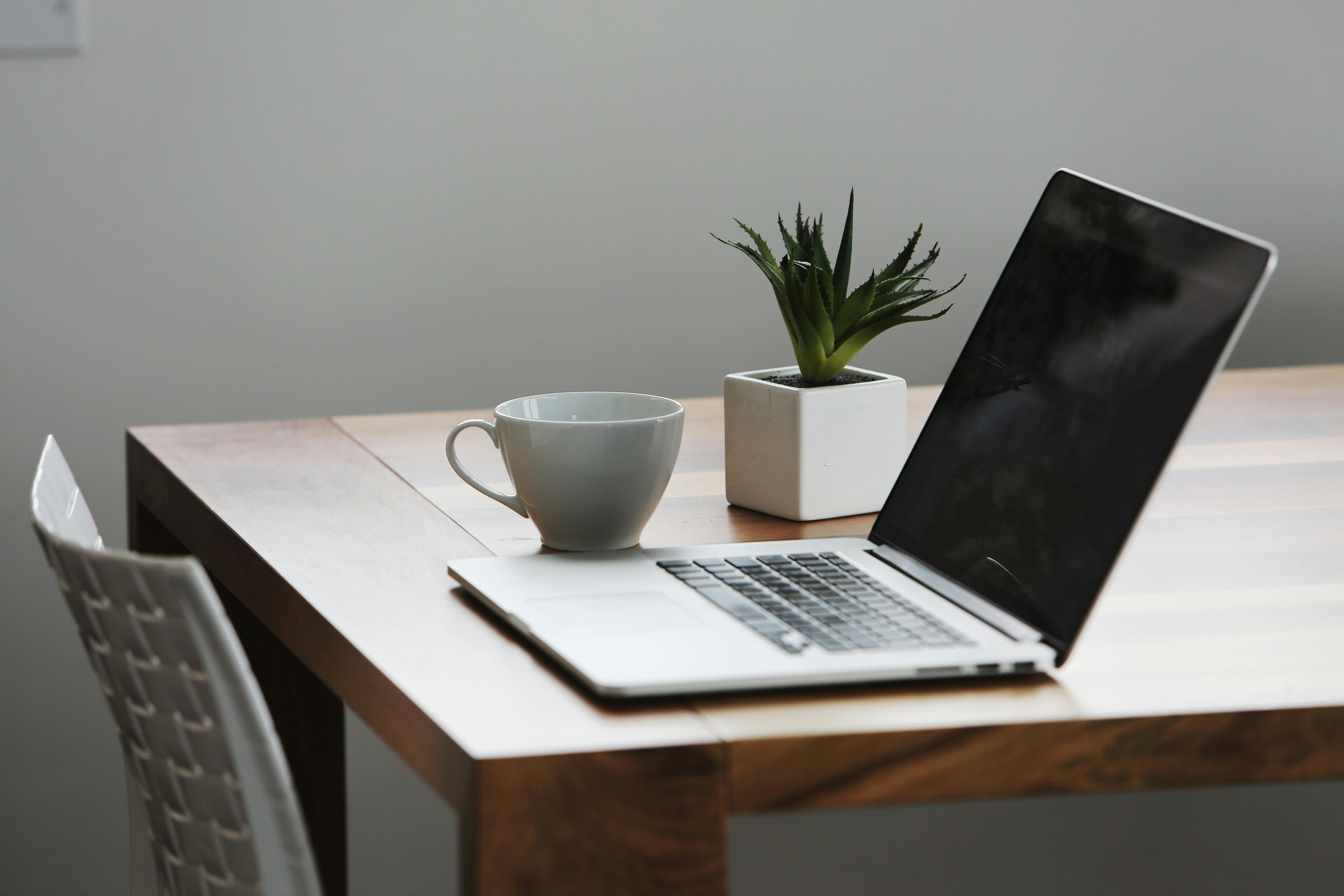 Modern workspace with laptop and notebook